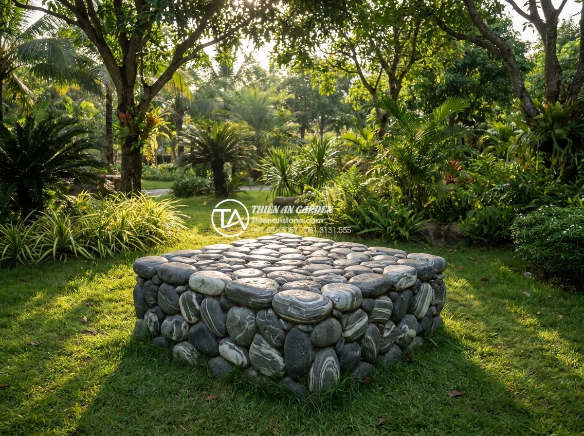 Bàn Trà Đá Nguyên Khối - Solid stone tea table centered on a lush green lawn under dappled tree shade, su