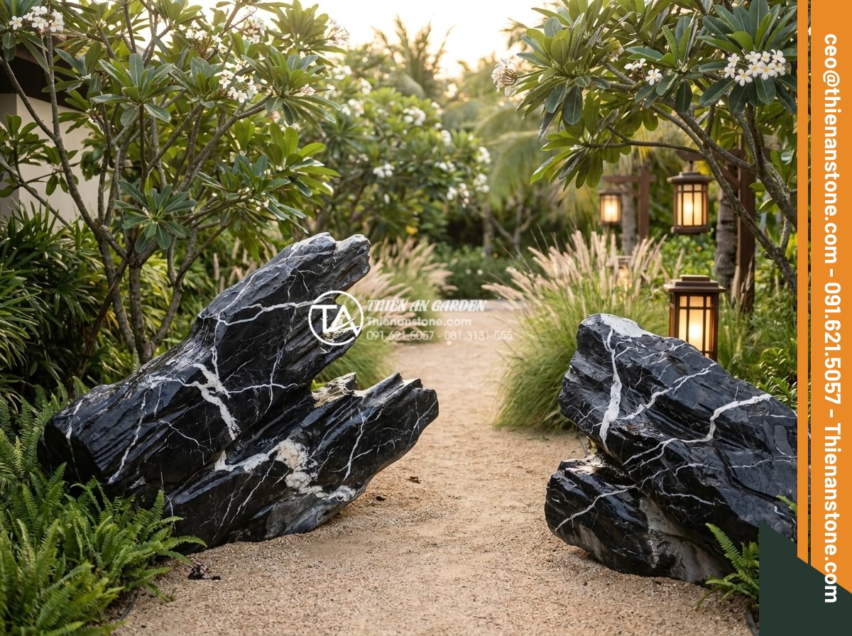 Đá Cảnh Tự Nhiên - Natural ornamental stones flanking the entrance pathway of a luxury Vietnamese r