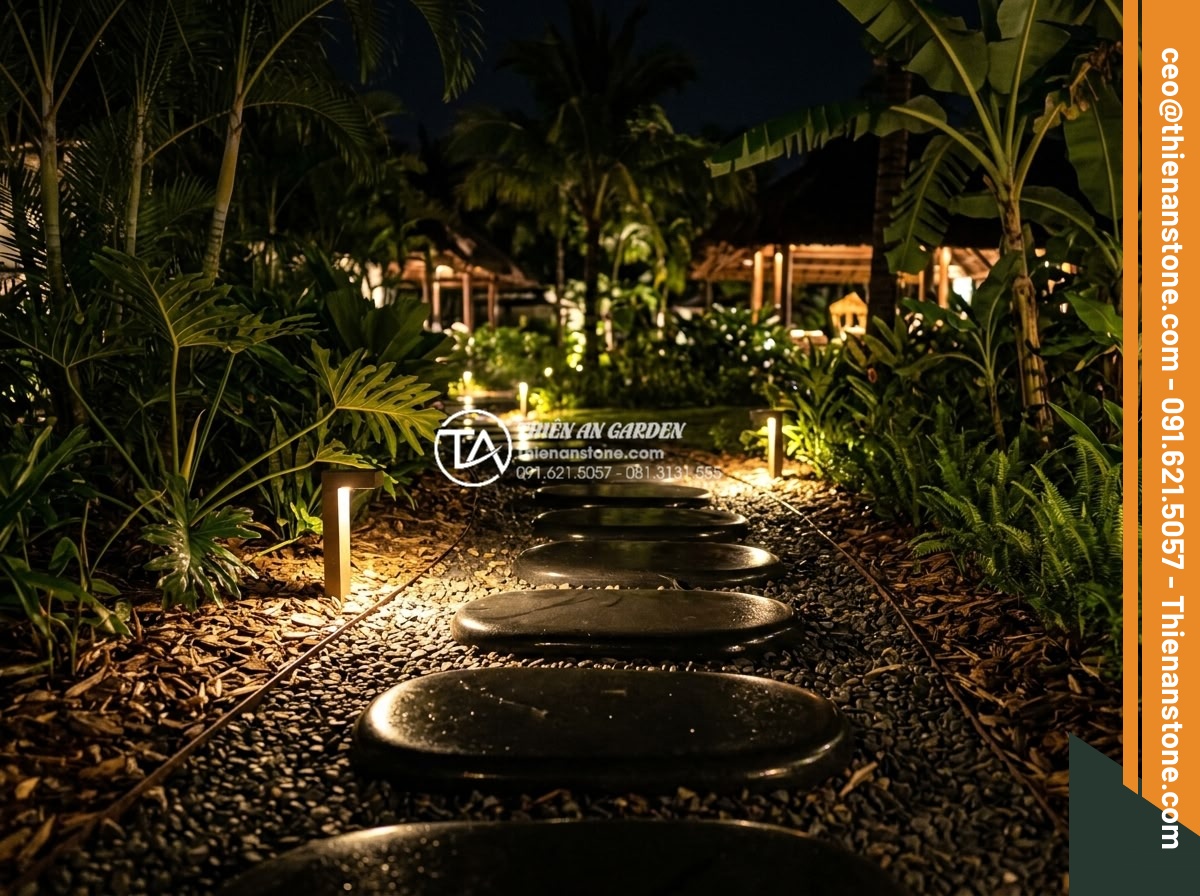Đá Dặm Bước - Night view of illuminated stepping stone path in resort garden, warm ground ligh
