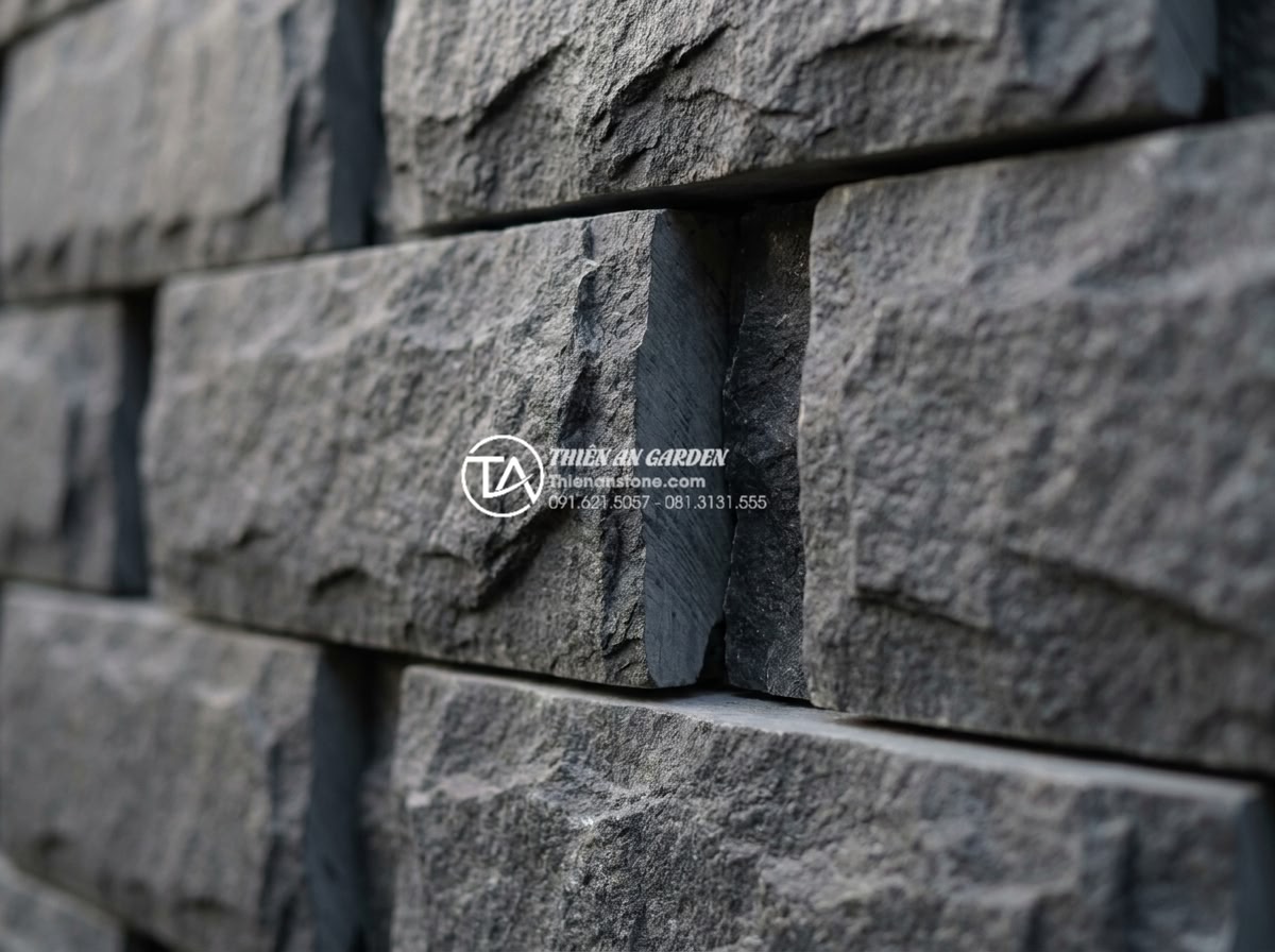 Đá Ghép Ốp Tường - Close-up of stacked natural stone cladding showing rough textured front face and