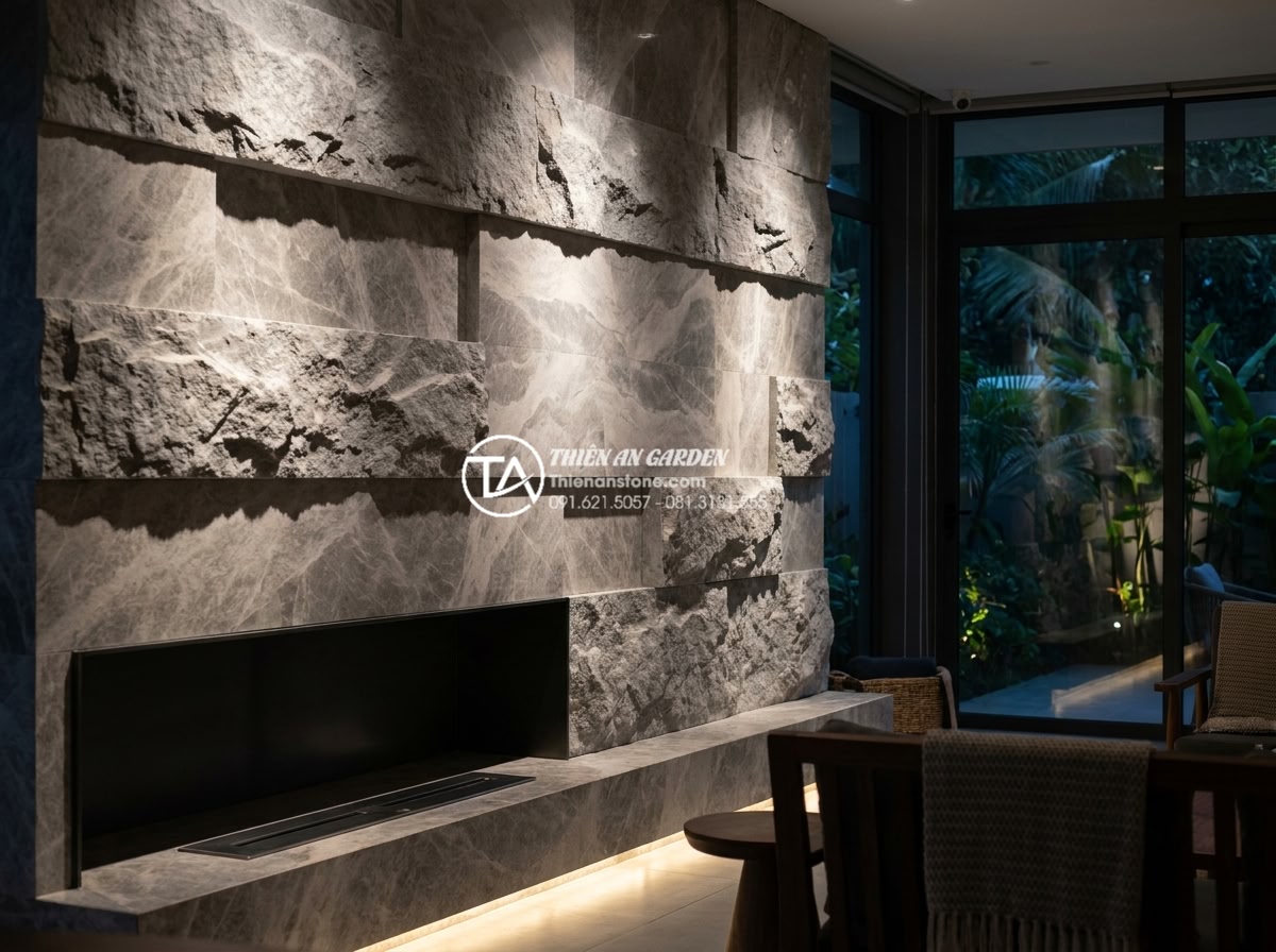 Đá Ốp Tường - Hình 18 Đá Ốp Tường - Split-face natural stone wall with dramatic wash lighting from below, deep shado