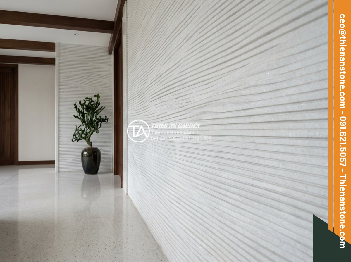Đá Răng Lược - Hình 14 Đá Răng Lược - White marble comb stone wall cladding in a luxury spa entrance, soft diffused li