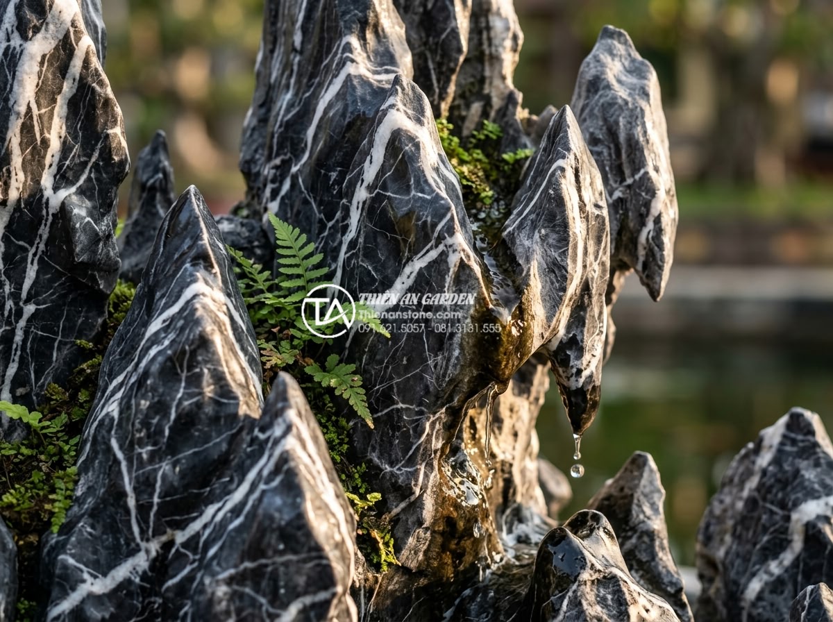 Tiểu Cảnh Non Bộ Sân Vườn - Close-up of tai meo limestone rockery arrangement showing sharp angular surfaces