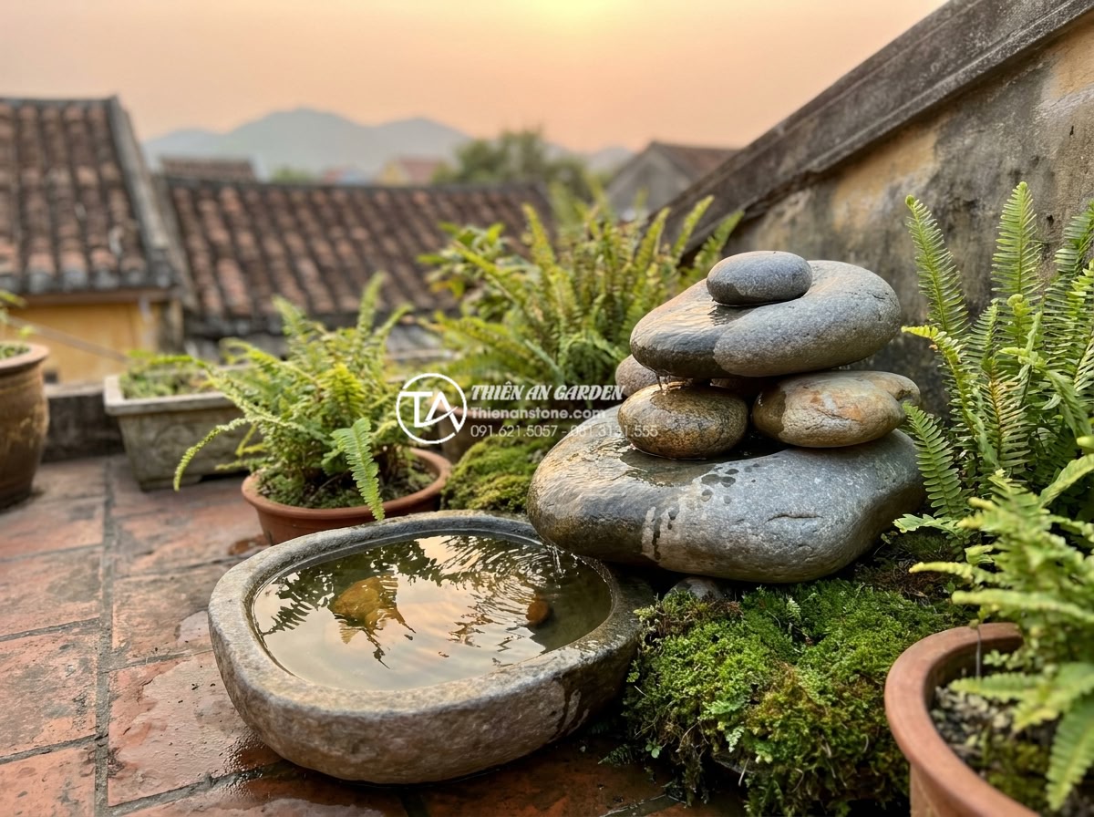 Tiểu Cảnh Sân Thượng - Small natural stone water feature on a rooftop terrace, water trickling over sta