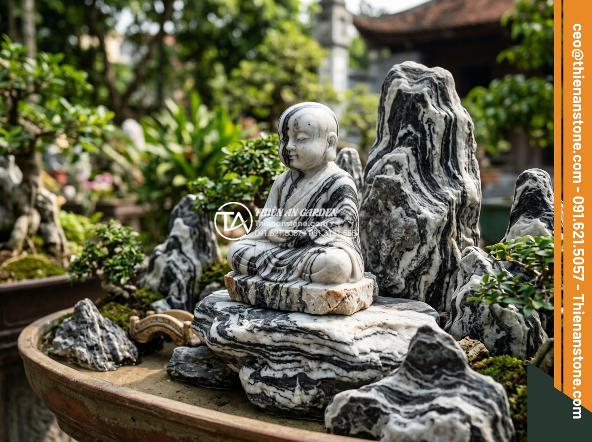 Cách thiết kế tiểu cảnh chú tiểu non bộ chuẩn phong thủy cho sân vườn - Handcrafted young monk statue from premium natural stone next to various rock fo