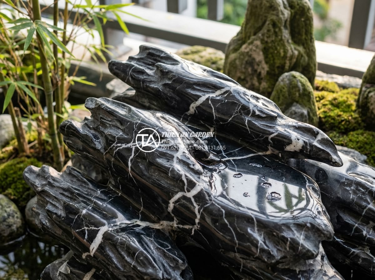Thiết kế tiểu cảnh góc sân vườn cho người mệnh Kim thu hút tài lộc - Close-up of polished natural stone elements in a Feng Shui garden designed speci