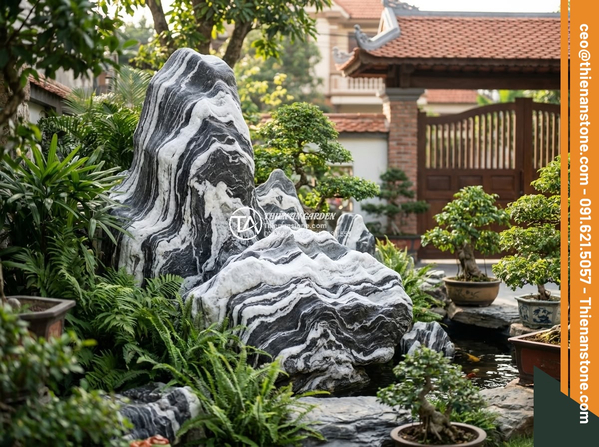 Hòn Non Bộ Đá Tuyết Sơn: Vẻ Đẹp Đẳng Cấp Cho Biệt Thự Sân Vườn - Happy customers standing beside their newly installed elegant Tuyet Son stone ro