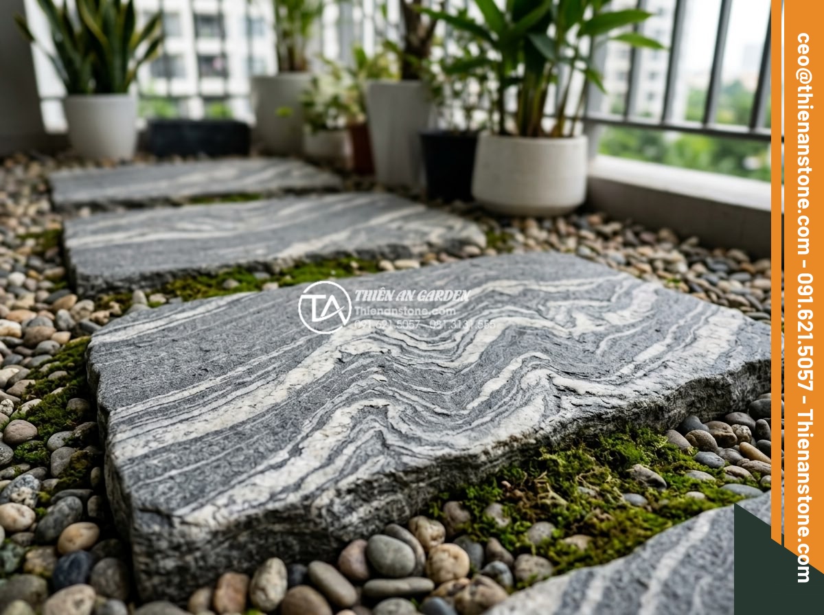 Có nên dùng đá dặm bước cho lối đi ban công chung cư? - Close-up detailed view of textured basalt stepping stones for balcony path in co