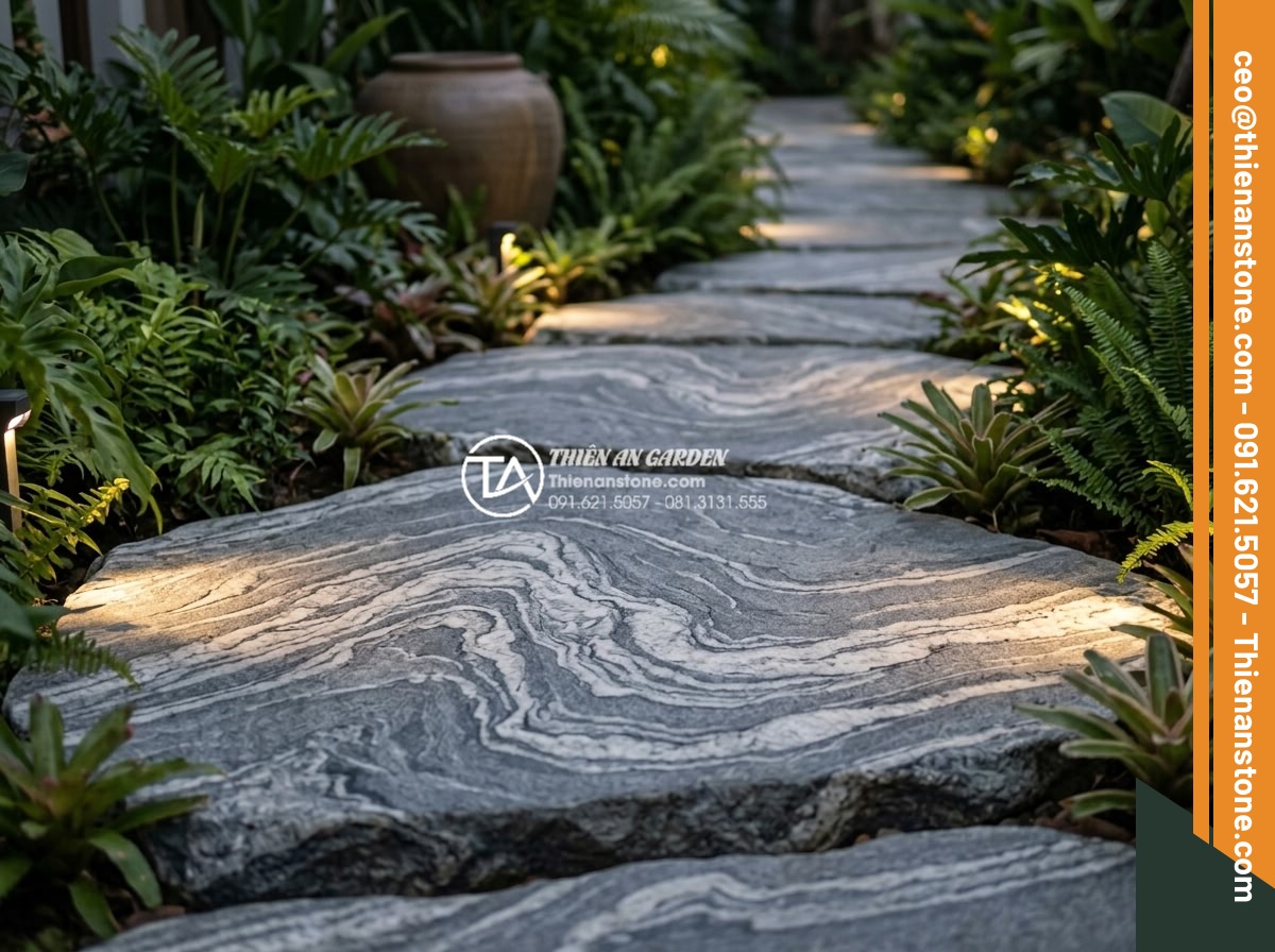 FAQ: Những câu hỏi thường gặp nhất khi chọn mua đá dặm bước - Close-up view of textured natural stone stepping stones arranged in a modern gar