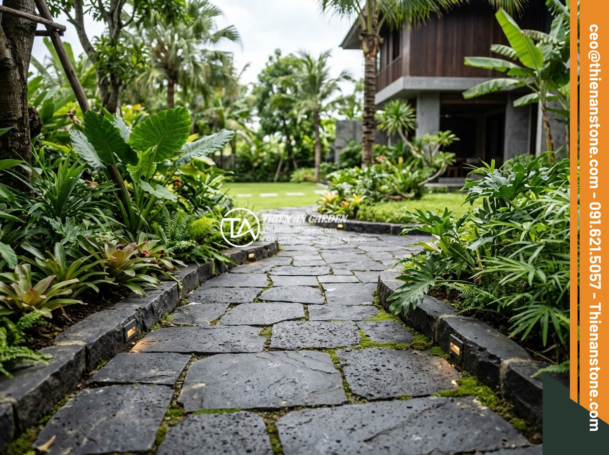 So sánh đá dặm bước bazan và đá slate: Nên chọn loại nào cho lối đi? - Detailed view of slate pathway in a high-end villa garden with integrated lighti