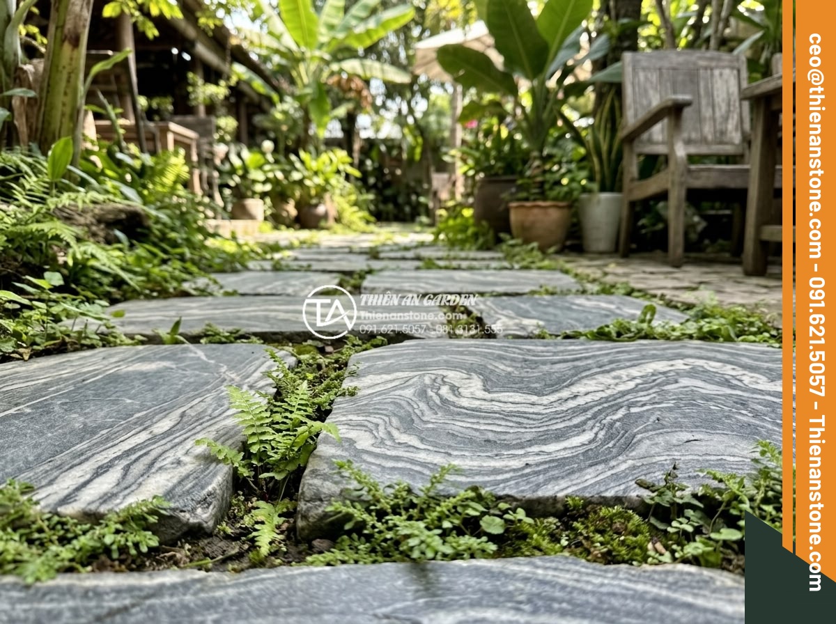 Ứng dụng đá bước dạo trong thiết kế quán cafe sân vườn cực chill - Detailed close-up of polished granite stepping stones in various gray tones arra