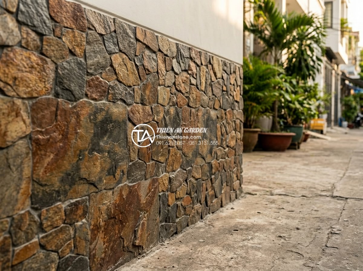 15+ Mẫu đá rối ốp chân tường giúp bảo vệ công trình tuyệt đối - Finished professional pebble stone cladding project on building base showing cle