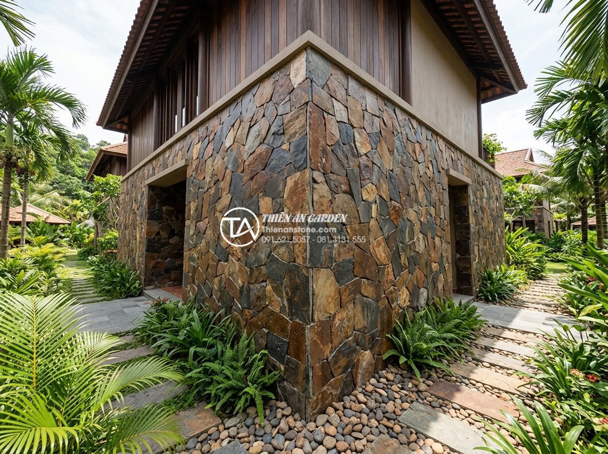 15+ Mẫu đá rối ốp chân tường giúp bảo vệ công trình tuyệt đối - Wide angle view of complete stone pebble wall base cladding installation on a lu