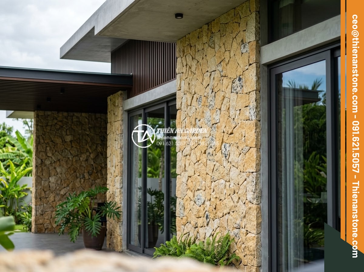 Cách chọn màu đá rối hợp mệnh gia chủ trong kiến trúc - Artistic rubble stone wall cladding on modern villa facade with natural textures