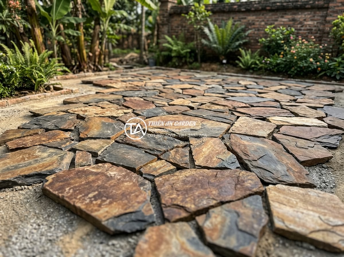 Quy trình lát sân bằng đá rối: Checklist 5 bước đạt chuẩn chuyên gia - Detailed dry layout of tumbled stones showing artistic random pattern before per