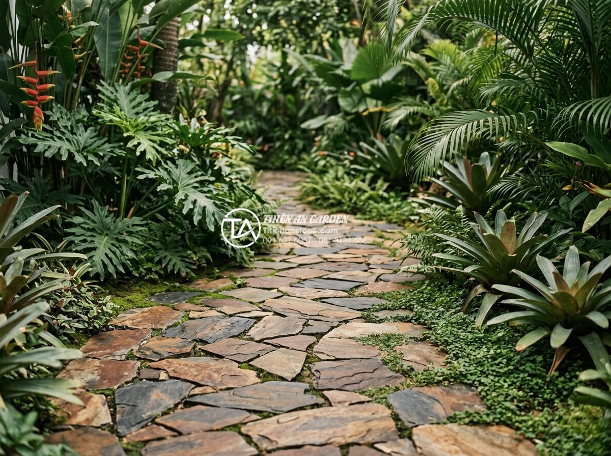 Quy trình lát sân bằng đá rối: Checklist 5 bước đạt chuẩn chuyên gia - Luxurious tropical garden yard paved with natural tumbled stones, demonstrating 
