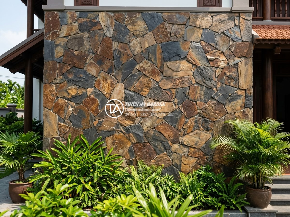 Ưu điểm của đá rối vàng ốp tường trong phong thủy nhà ở - Wide angle shot of a luxurious villa exterior wall fully clad with golden chaoti