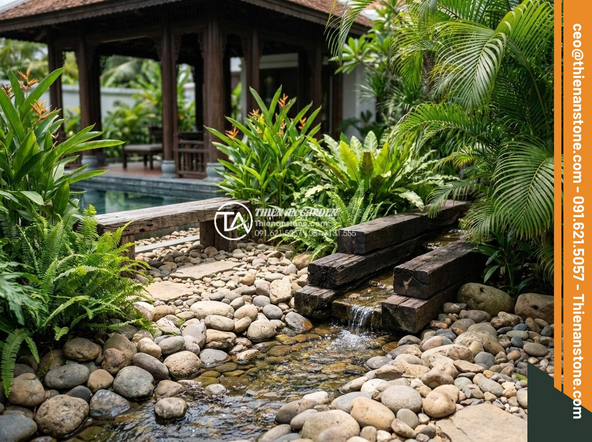 Đá cuội sân vườn: Ý tưởng trang trí và hướng dẫn lát đá cuội đẹp hút mắt - Hình 14 Đá cuội sân vườn: Ý tưởng trang trí và hướng dẫn lát đá cuội đẹp hút mắt - Harmonious blend of pebble stones, tropical plants, wooden elements and water fe