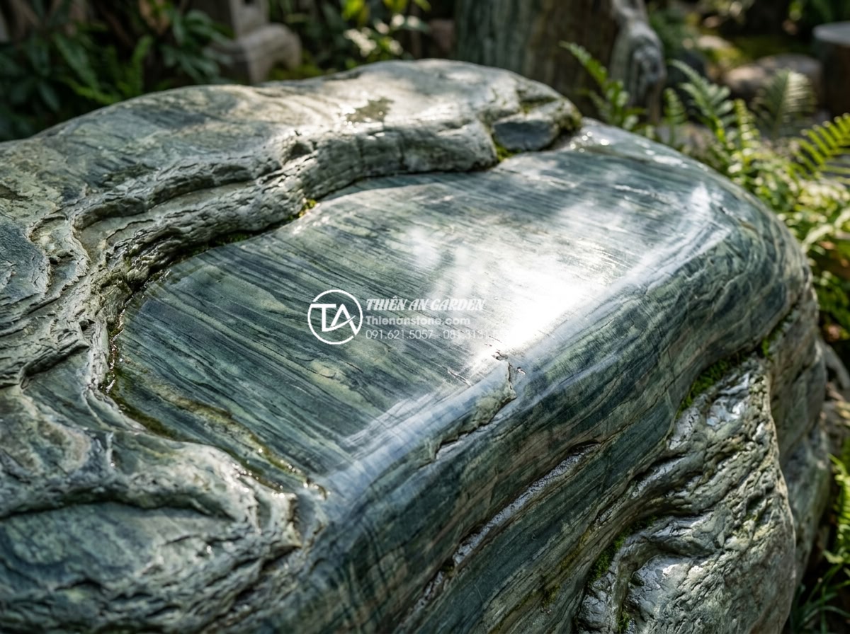 Đá xanh Nhật Bản là gì? Tại sao đây là lựa chọn số 1 cho cảnh quan cao cấp? - Detailed close-up of polished Japanese green stone surface reflecting sunlight w