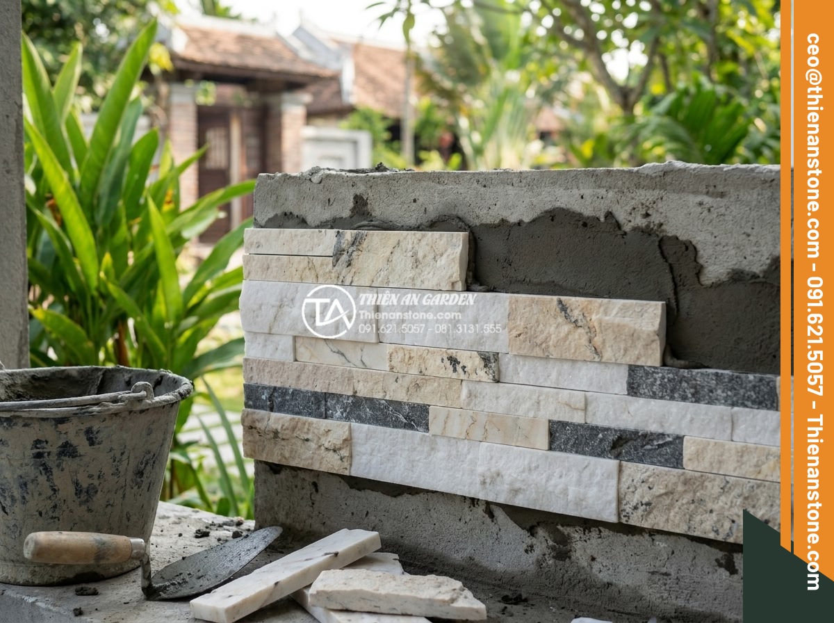 So sánh đá ghép tự nhiên và gạch giả đá: Nên chọn loại nào để ốp tường? - Professional construction team installing natural stone wall cladding on site wi