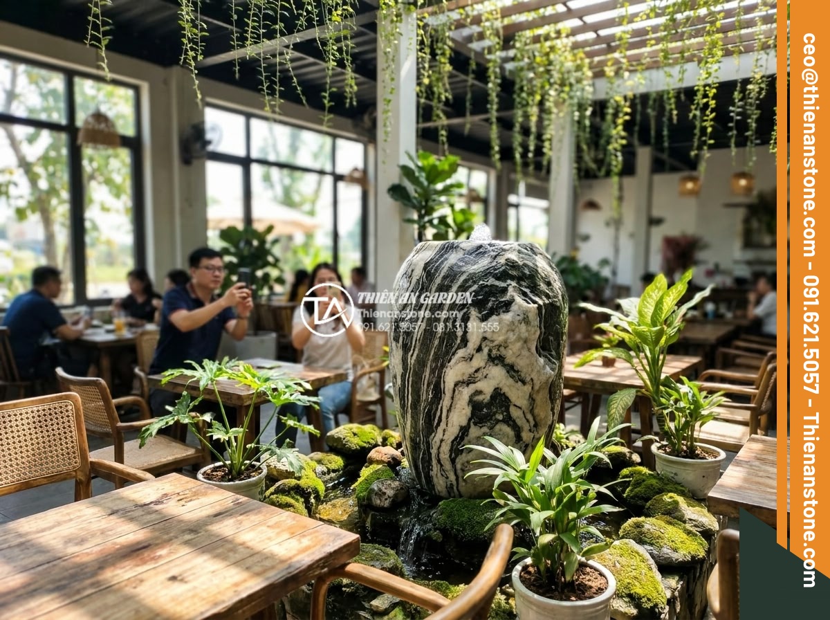 Tiểu cảnh chum nước cho quán cafe: Tuyệt chiêu thu hút khách check-in - Vibrant cafe interior with stone water feature jar creating peaceful ambiance, c