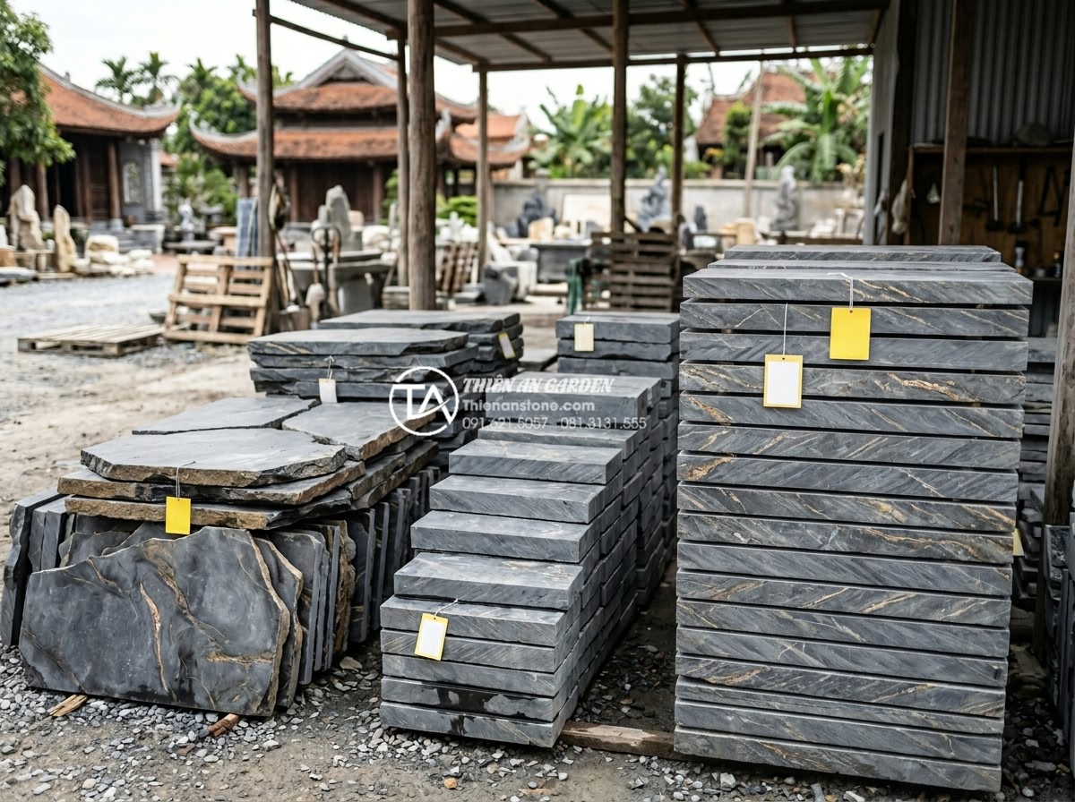 Bảng giá đá trầm tích các loại mới nhất 2026 cho công trình cảnh quan - Hình 8 Bảng giá đá trầm tích các loại mới nhất 2026 cho công trình cảnh quan - Realistic scene of stacked sedimentary stone slabs with price tags visible in a