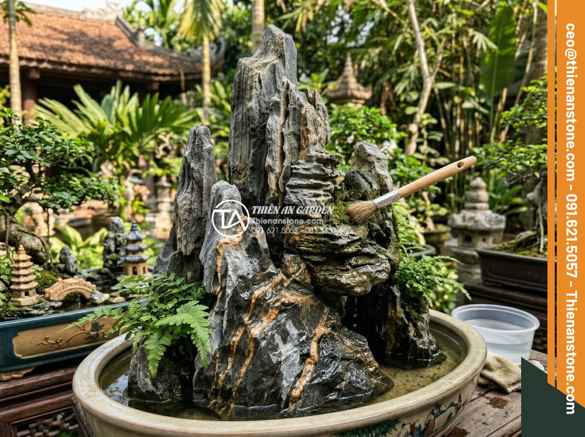 Nghệ thuật sử dụng đá trầm tích trong thiết kế hòn non bộ và tiểu cảnh - Maintenance process for sedimentary rock hòn non bộ, technician gently cleaning 