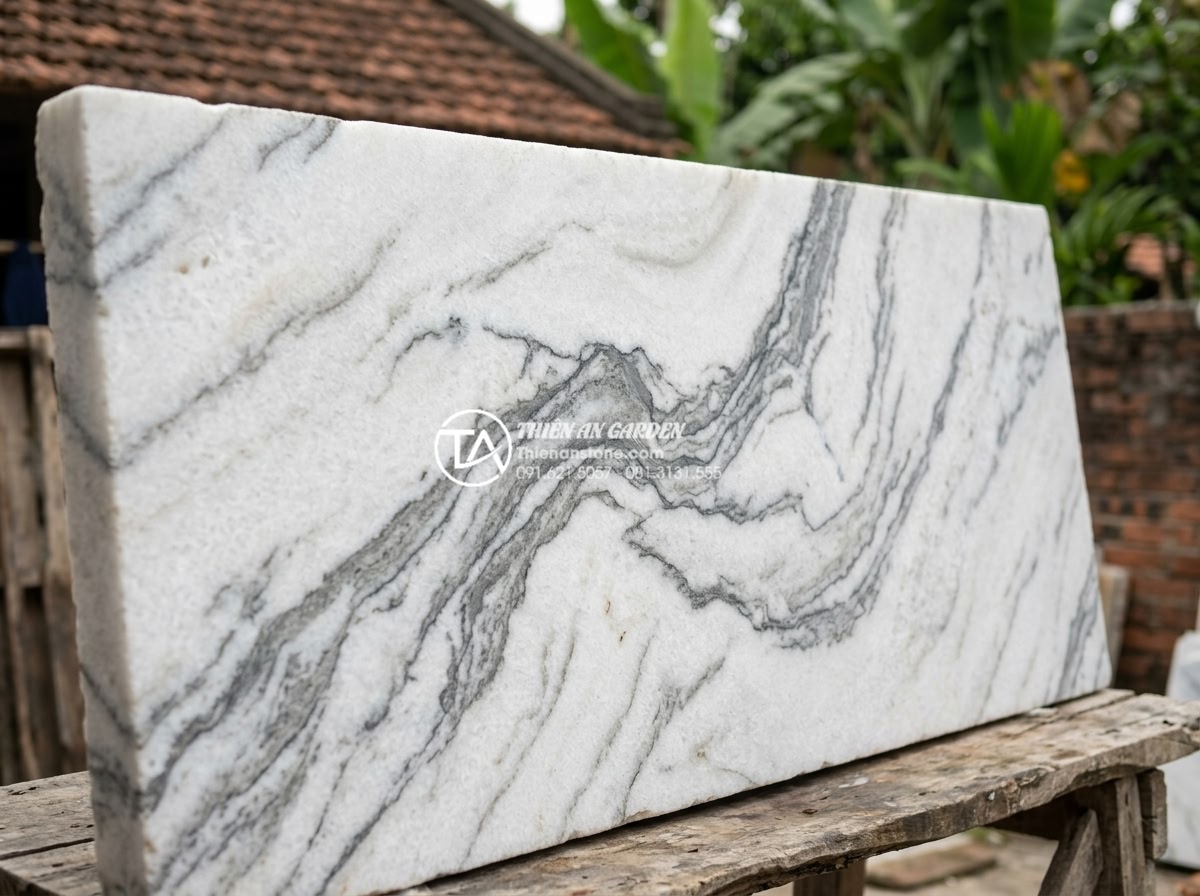 Bí quyết chọn đá tuyết sơn làm biển hiệu công ty chuẩn phong thủy - Close-up view of premium snow mountain stone slab with natural white surface and