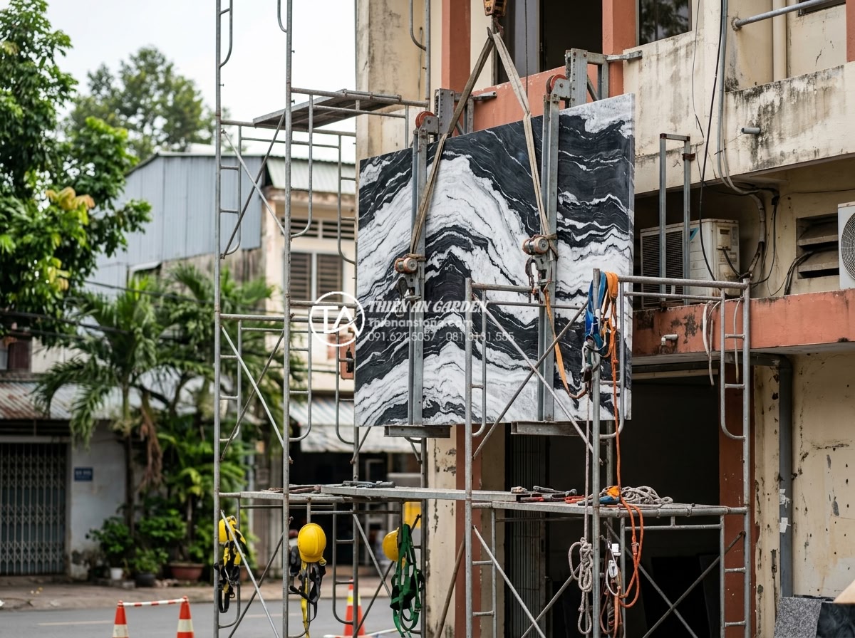 Bí quyết chọn đá tuyết sơn làm biển hiệu công ty chuẩn phong thủy - Installation team mounting large snow mountain stone company sign on commercial 