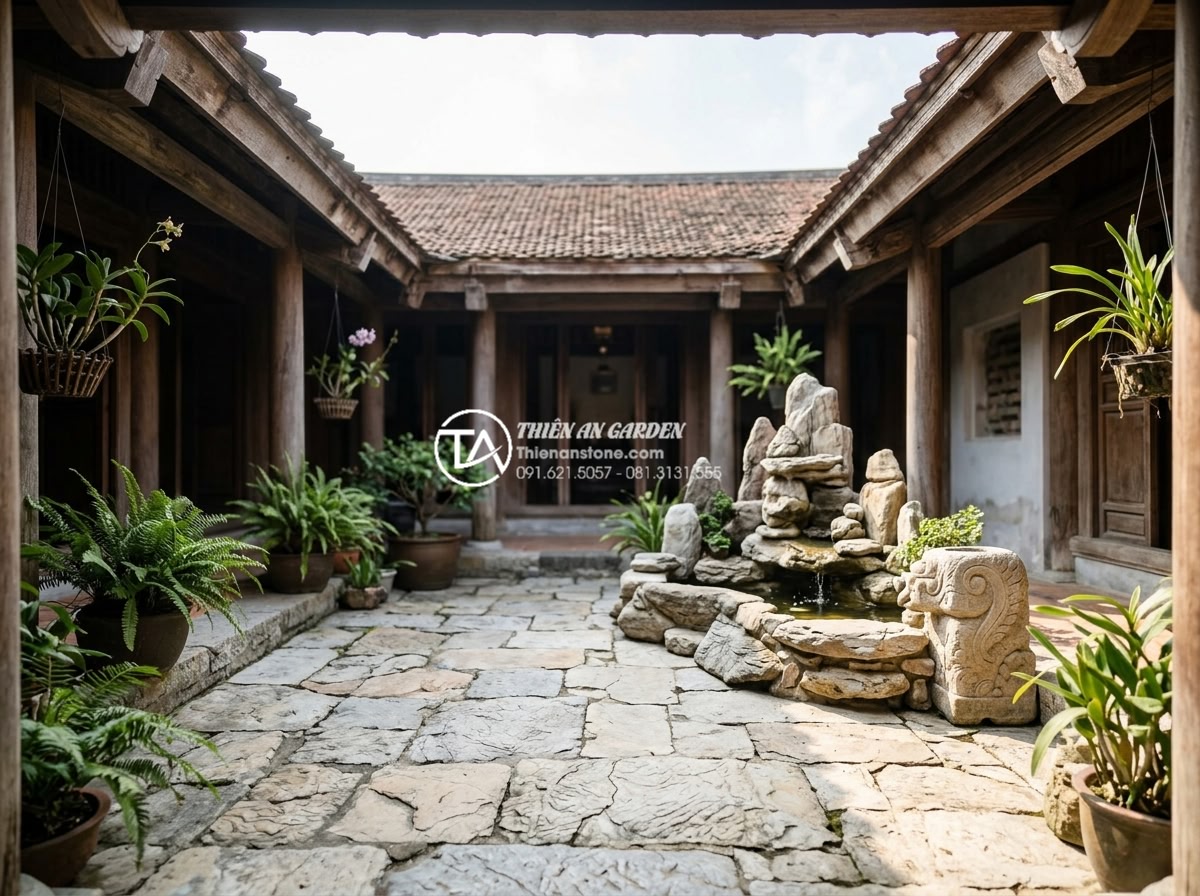 Phong thủy giếng trời: Những điều đại kỵ cần tránh để không hao tài - Hình 1 Phong thủy giếng trời: Những điều đại kỵ cần tránh để không hao tài - A serene Vietnamese traditional house atrium featuring natural stone paving and