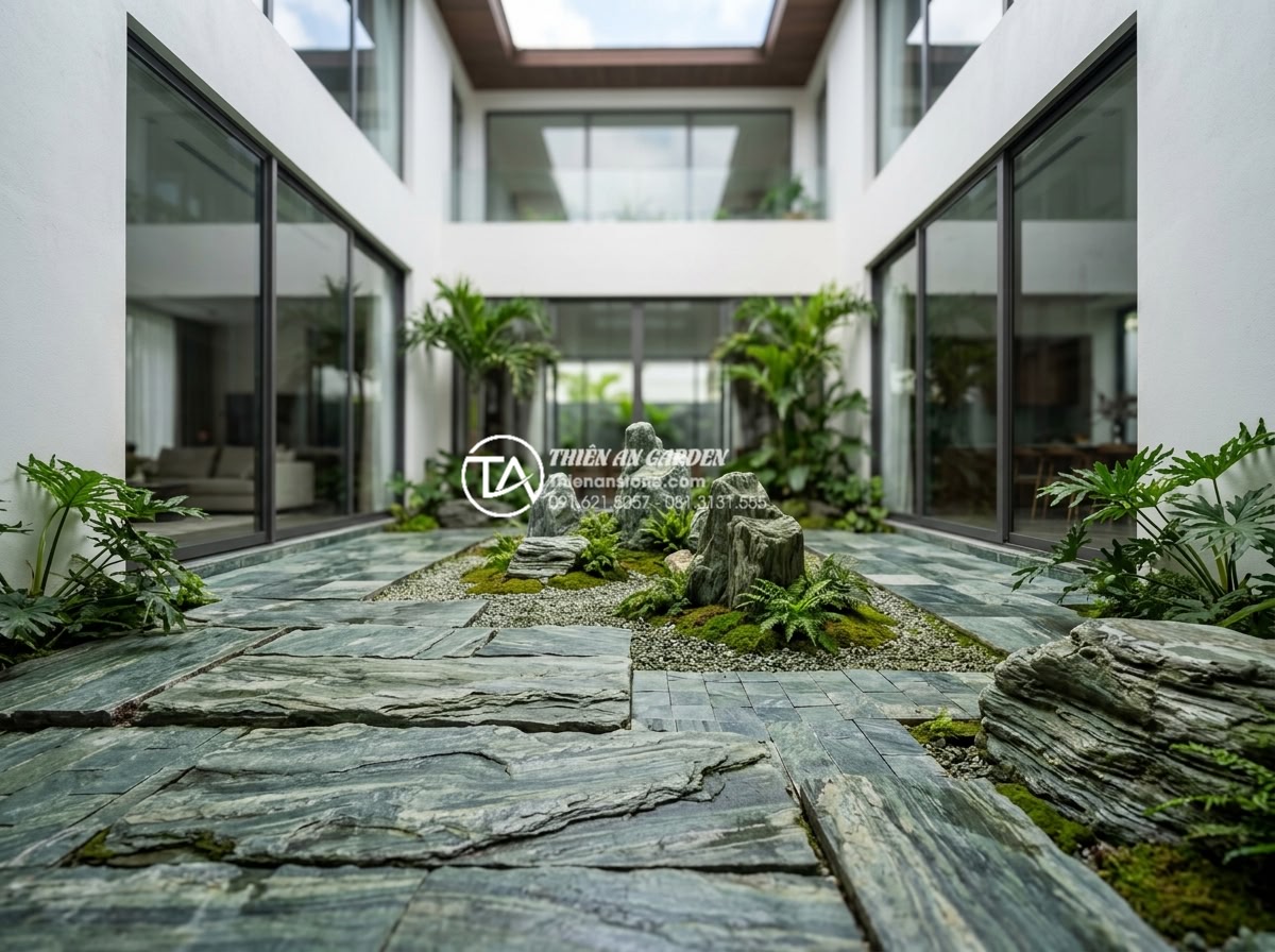 Top 5 loại đá tự nhiên ốp tường giếng trời bền đẹp và sang trọng nhất - Contemporary basalt tiled atrium featuring bold textures and natural stone finis