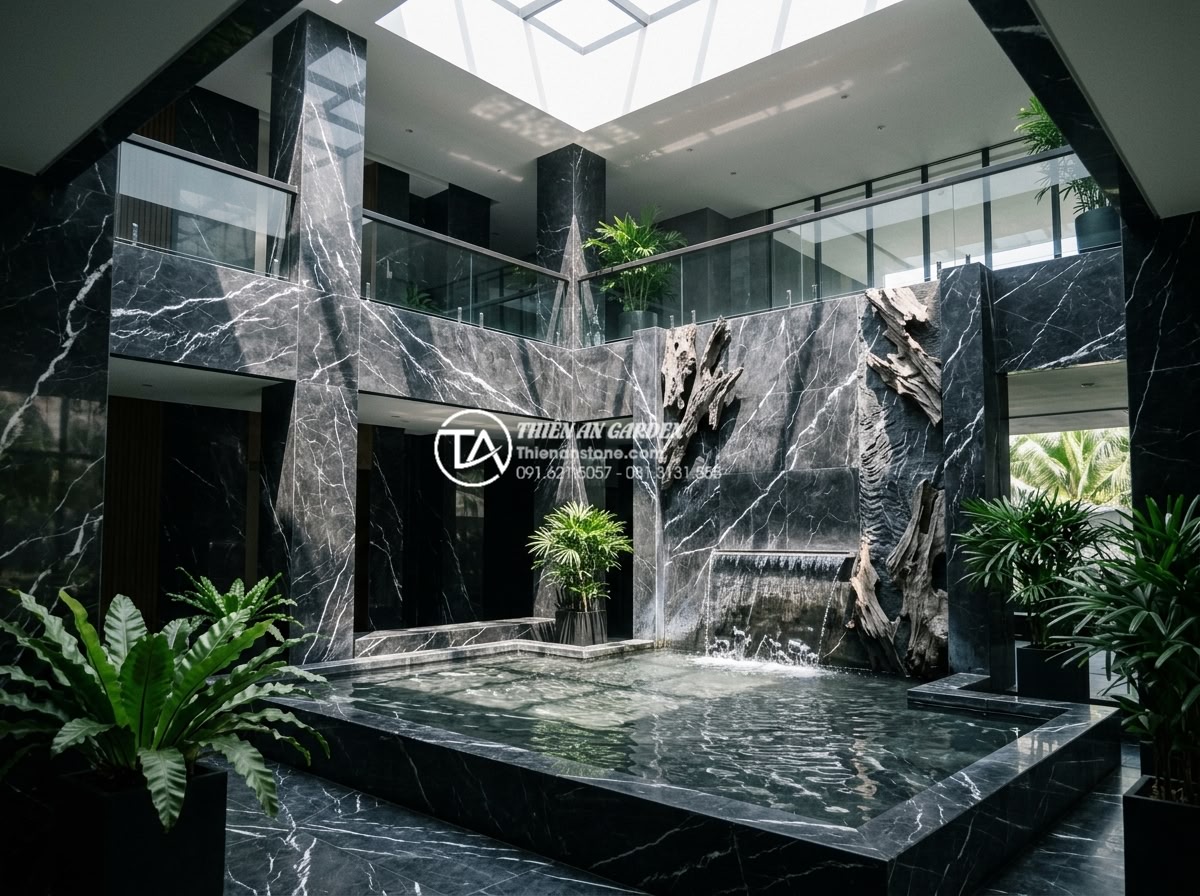 Top 5 loại đá tự nhiên ốp tường giếng trời bền đẹp và sang trọng nhất - Modern atrium featuring high-quality granite cladding with integrated water elem