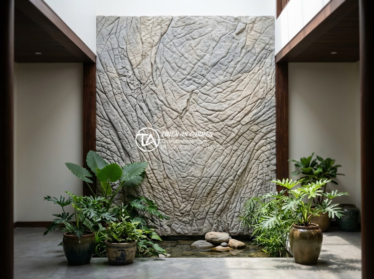 Ứng dụng tranh đá ốp tường giếng trời tạo điểm nhấn nghệ thuật - Hình 20 Ứng dụng tranh đá ốp tường giếng trời tạo điểm nhấn nghệ thuật - Happy client standing in front of their newly installed artistic stone atrium mu
