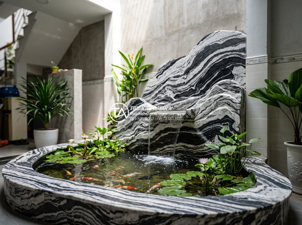 Ý tưởng biến giếng trời sau nhà ống thành tiểu cảnh xanh mát - Small koi pond with waterfall made from carved stones at the base of a light wel
