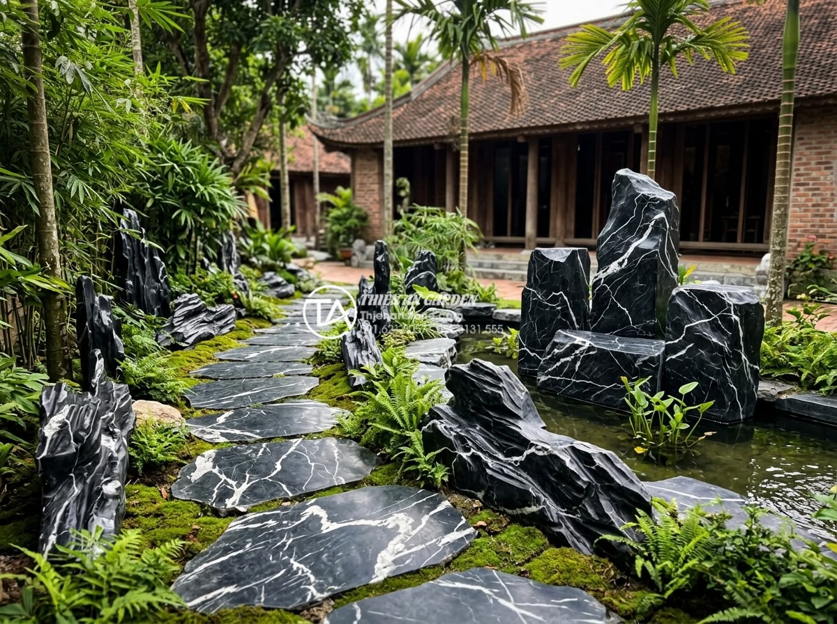 Báo giá thi công tiểu cảnh làng quê Bắc Bộ trọn gói mới nhất 2026 - Professional team of stone craftsmen and designers at Thien An Stone company wor