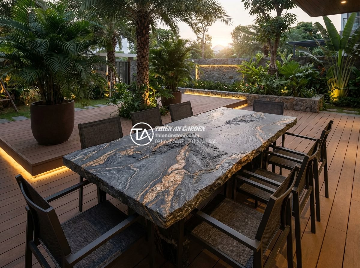 Bàn ghế đá hoa cương (Granite): Đặc điểm, ưu điểm và các mẫu bền đẹp nhất - Hình 4 Bàn ghế đá hoa cương (Granite): Đặc điểm, ưu điểm và các mẫu bền đẹp nhất - High quality outdoor scene showing a large rectangular granite table with eight