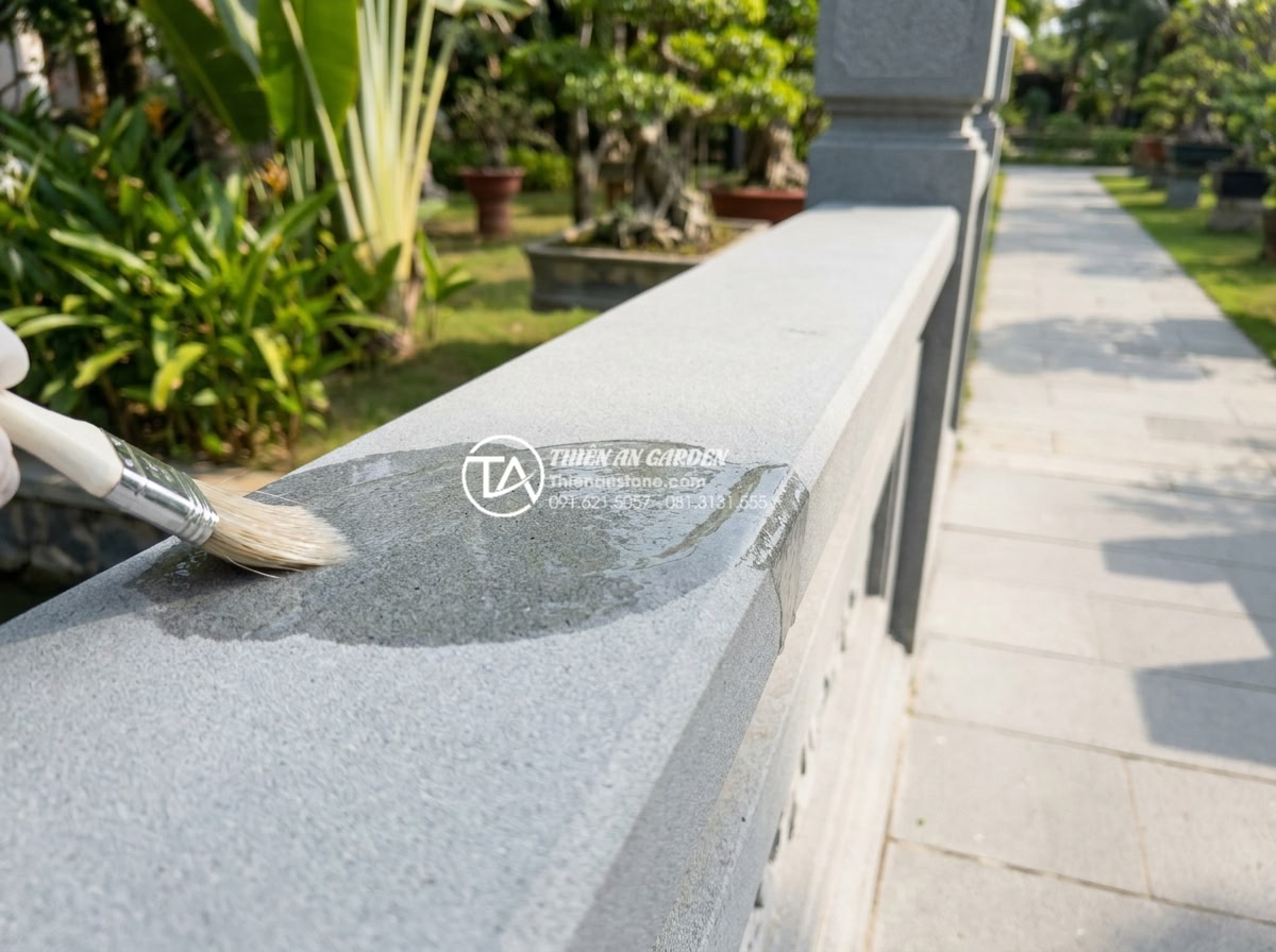 Ảnh hưởng của thời tiết đến độ bền cầu đá và cách bảo quản định kỳ - Technician from Thien An Stone applying advanced silane-based waterproofing trea
