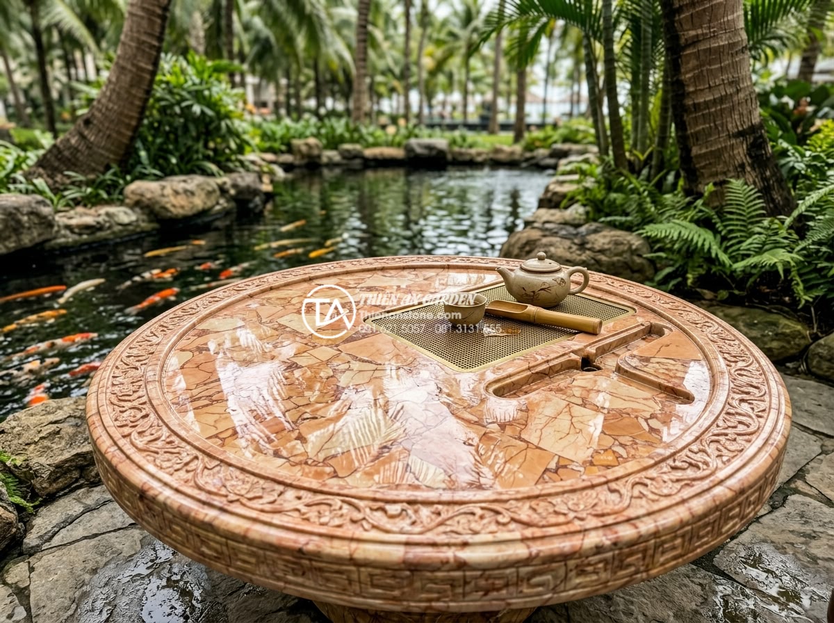 Case Study: Thi công hệ thống bàn trà đá nguyên khối cho Resort 5 sao - Close-up detail of a large round solid stone tea table with intricate hand-carve