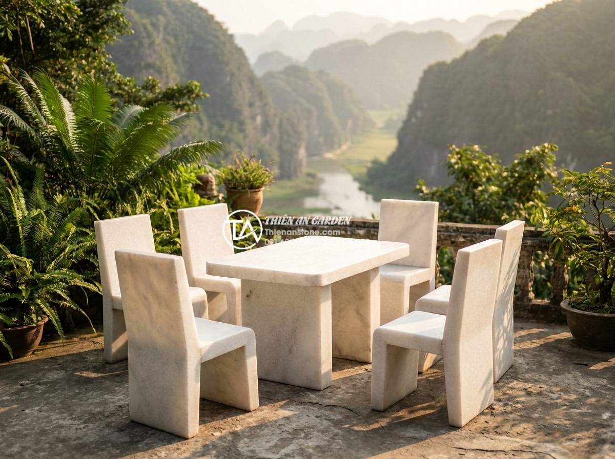 Địa chỉ mua bàn ghế đá tự nhiên uy tín tại Ninh Bình và Thanh Hóa - Hình 1 Địa chỉ mua bàn ghế đá tự nhiên uy tín tại Ninh Bình và Thanh Hóa - Elegant hand-carved natural stone garden table and chairs set placed on a limest