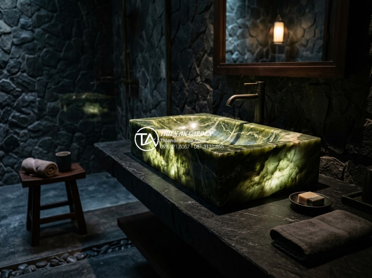 Lavabo Đá Nguyên Khối: Đẳng Cấp Sang Trọng Từ Sự Nguyên Sơ Và Bền Bỉ - Dramatic backlit onyx stone lavabo in deep emerald green tones glowing softly in