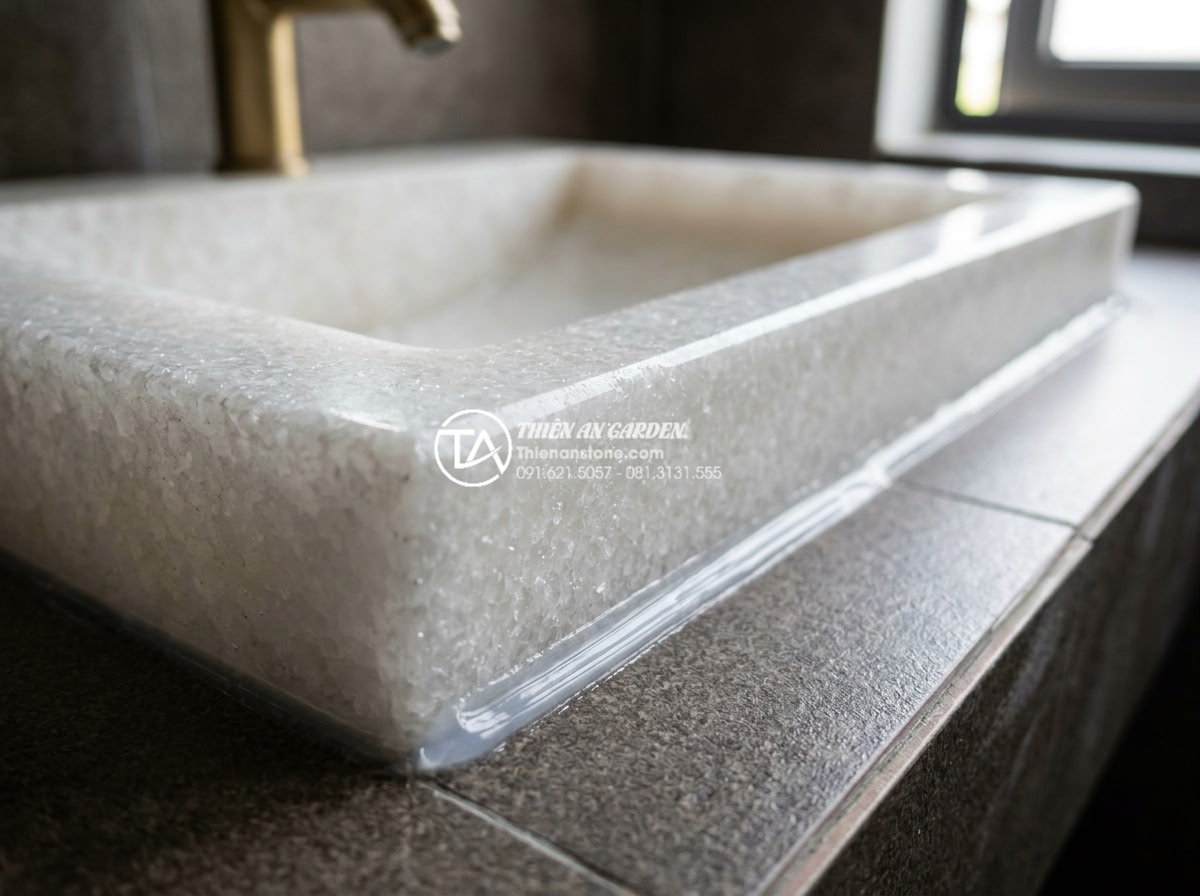 Lỗi Thường Gặp Khi Lắp Đặt Bàn Đá Chậu Rửa Mặt Và Cách Khắc Phục Triệt Để - Close-up of high-quality silicone sealing application around natural stone lavab