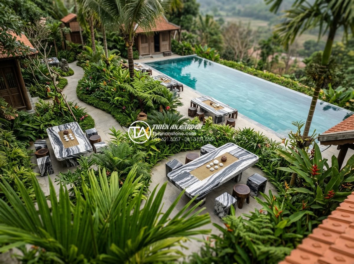 Mẫu bàn trà đá Granite (đá hoa cương) siêu bền cho khu vực ngoài trời - Aerial view of luxury resort garden featuring multiple granite tea tables strate