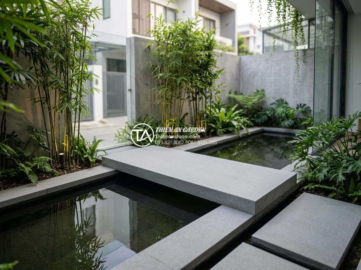 Phân loại các dáng cầu đá phổ biến: Cầu vòm, cầu phẳng và cầu dích dắc - Minimalist modern flat stone bridge made from polished black granite spanning a 