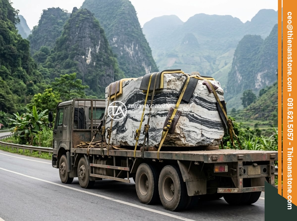 Quy trình chế tác bàn trà đá nguyên khối từ khối đá thô đến tác phẩm nghệ thuật - Heavy duty specialized truck transporting large rough stone block secured with s