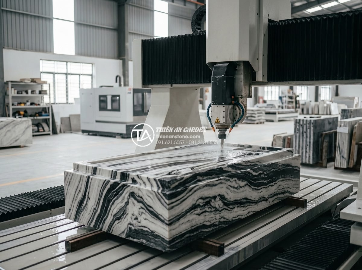 Sự khác biệt giữa bàn trà đá nguyên khối Việt Nam và đá nhập khẩu - Modern CNC cutting machine in a Vietnamese stone factory precisely shaping a mon