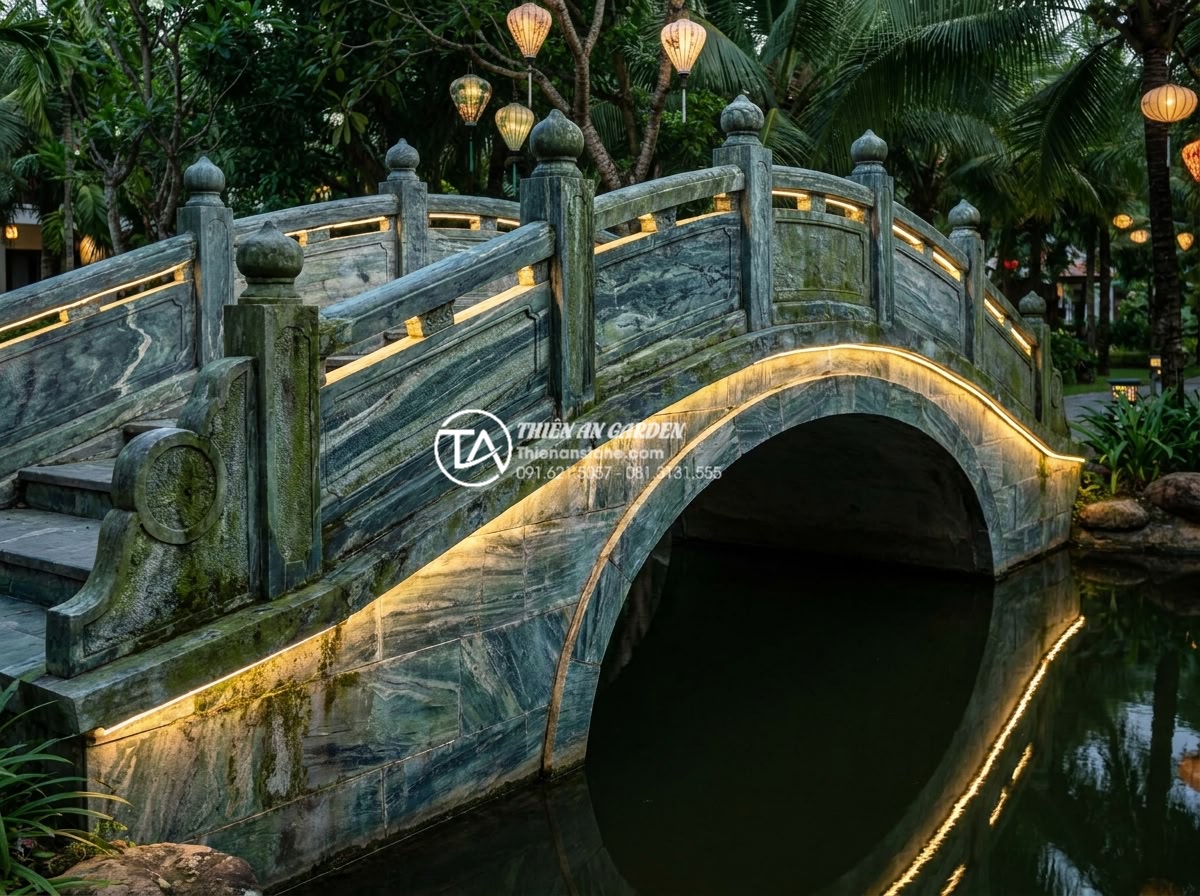 Tại sao cầu đá xanh Thanh Hóa lại được ưa chuộng nhất năm 2026? - Hình 8 Tại sao cầu đá xanh Thanh Hóa lại được ưa chuộng nhất năm 2026? - Nighttime view of an illuminated Thanh Hoa green stone garden bridge with subtle