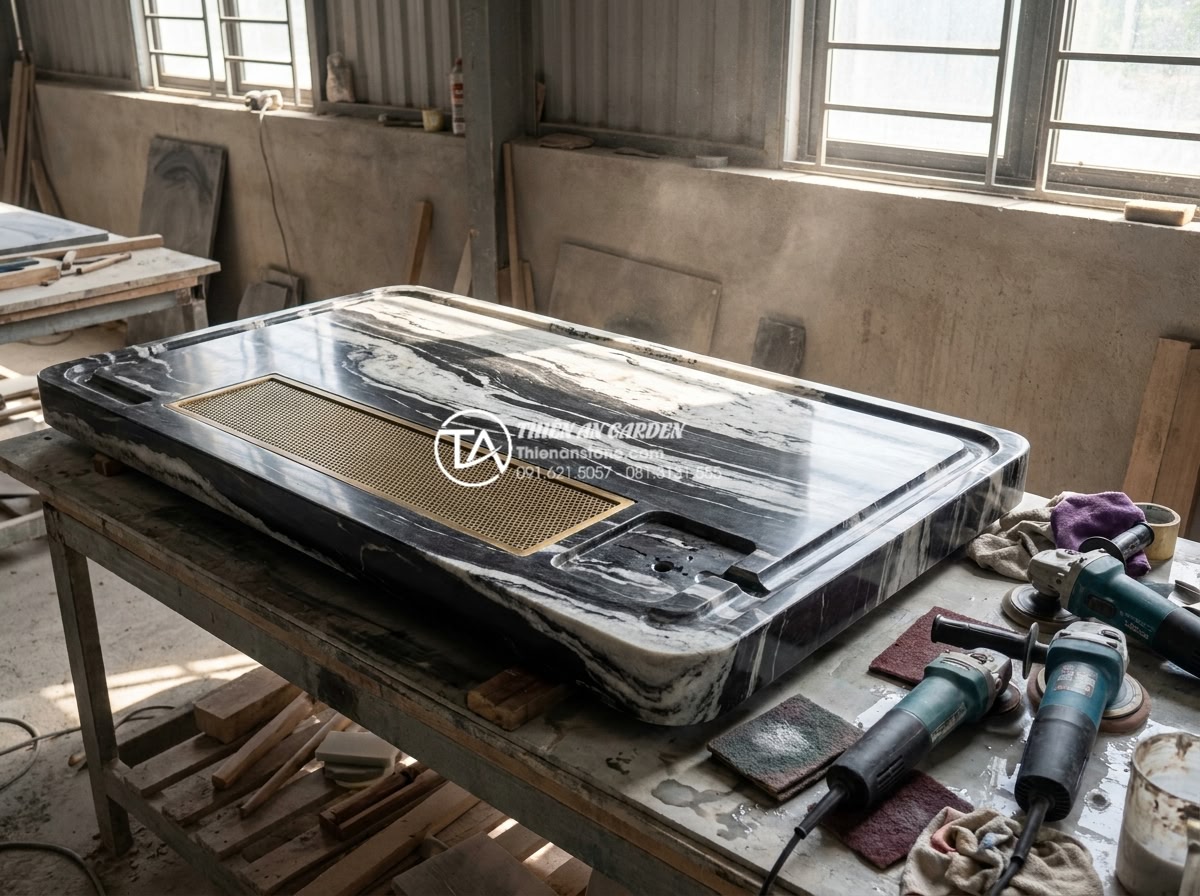 Top 10 mẫu bàn trà đá cuội nguyên khối đẹp nhất cho biệt thự sân vườn - Detailed 8K professional photo of a skilled artisan hand-polishing a large monol