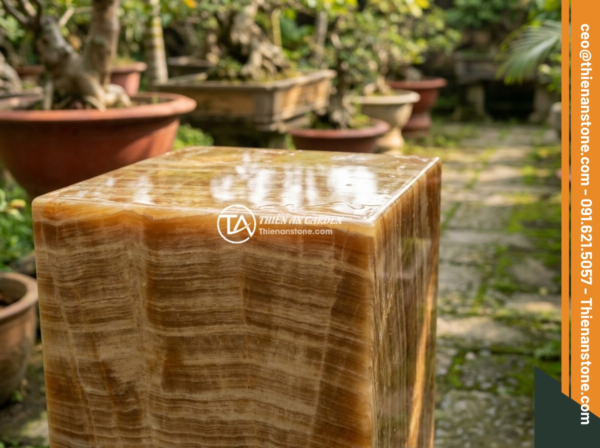 Cách bảo quản và vệ sinh đôn đá tự nhiên luôn sáng bóng, bền màu - A beautiful natural stone pedestal displayed in an elegant Vietnamese garden set
