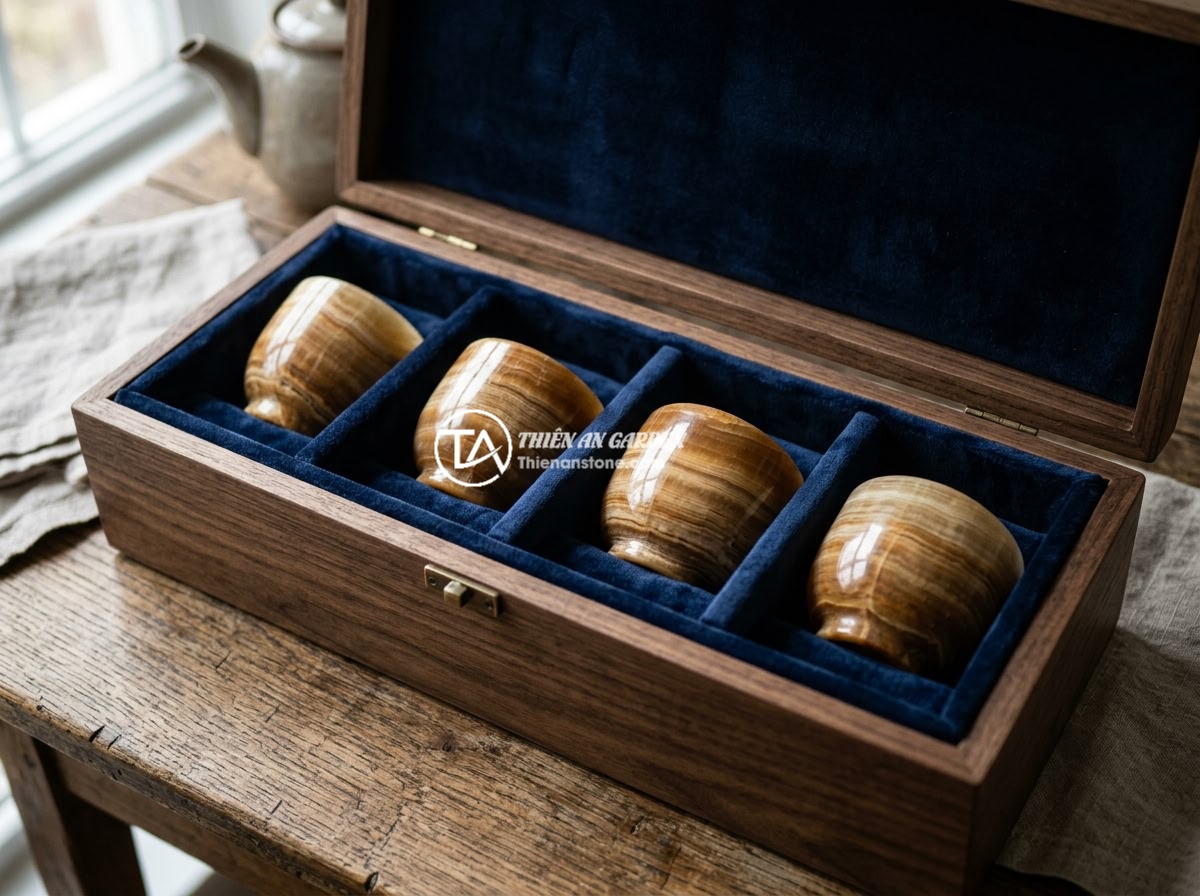 Lỗi thường gặp khi dùng bộ ấm chén đá và cách khắc phục triệt để - A set of natural stone teacups stored individually in a padded wooden box with s