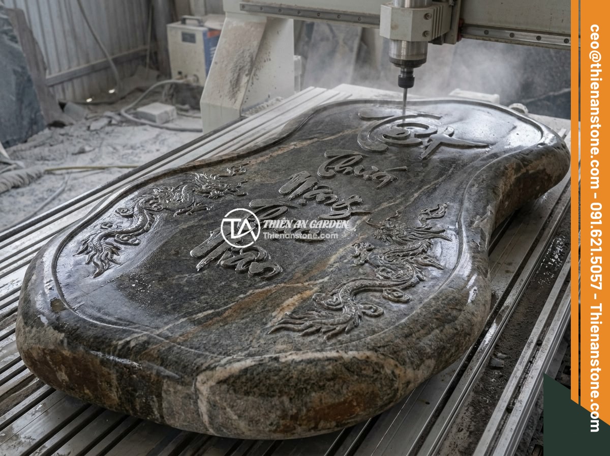So sánh bảng hiệu đá tự nhiên và bảng hiệu inox: Nên chọn loại nào cho doanh nghiệp? - Detailed CNC engraving process on a large natural granite stone slab creating in
